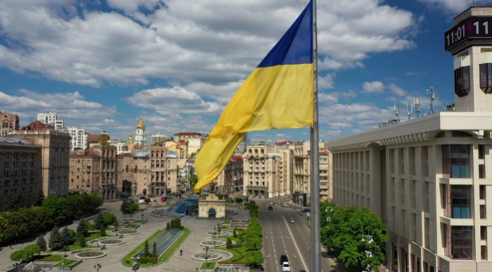 Ukraine flag flying over a city street